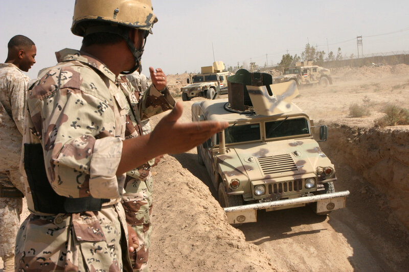 Soldiers with military vehicles in desert