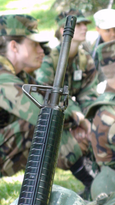 soldiers with rifle in focus