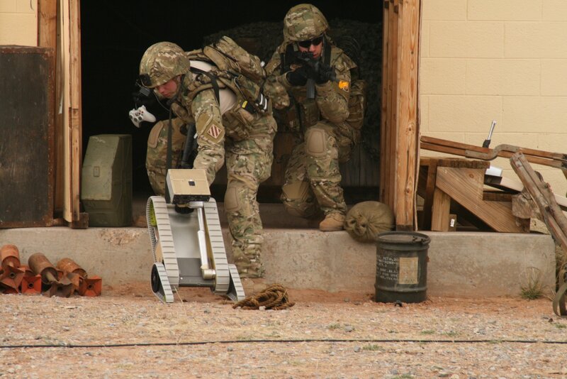 Soldiers with robot at building entrance