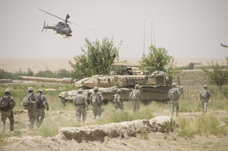 Soldiers with tank and helicopter
