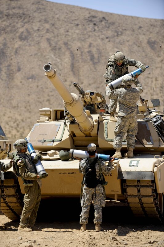 Soldiers with tank in desert