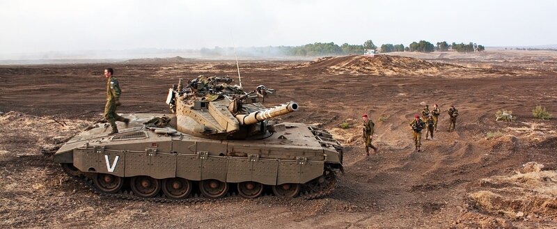 Soldiers with tank in desert