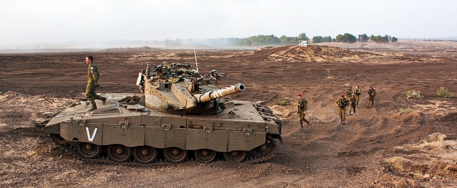 Soldiers with tank in desert