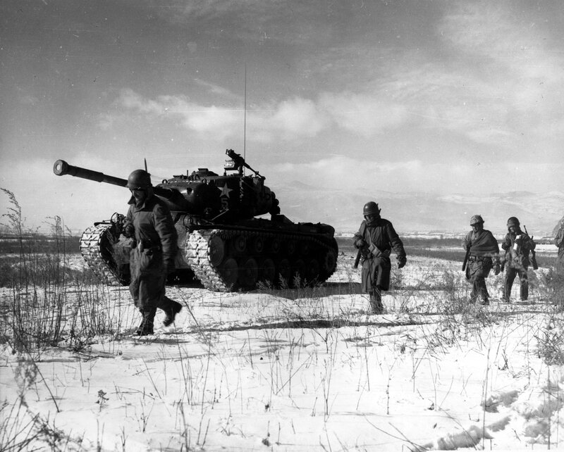 Soldiers with tank in snowy field
