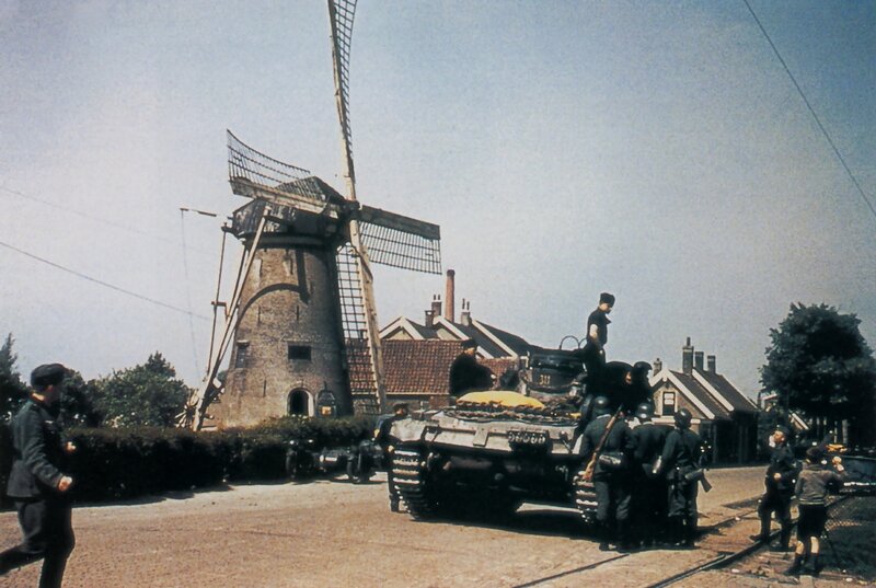 Soldiers with tank near windmill