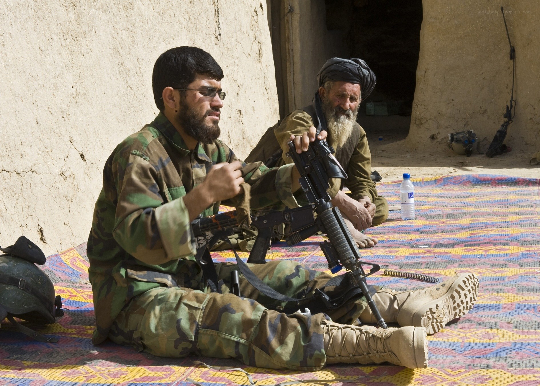Soldiers with weapons on mat