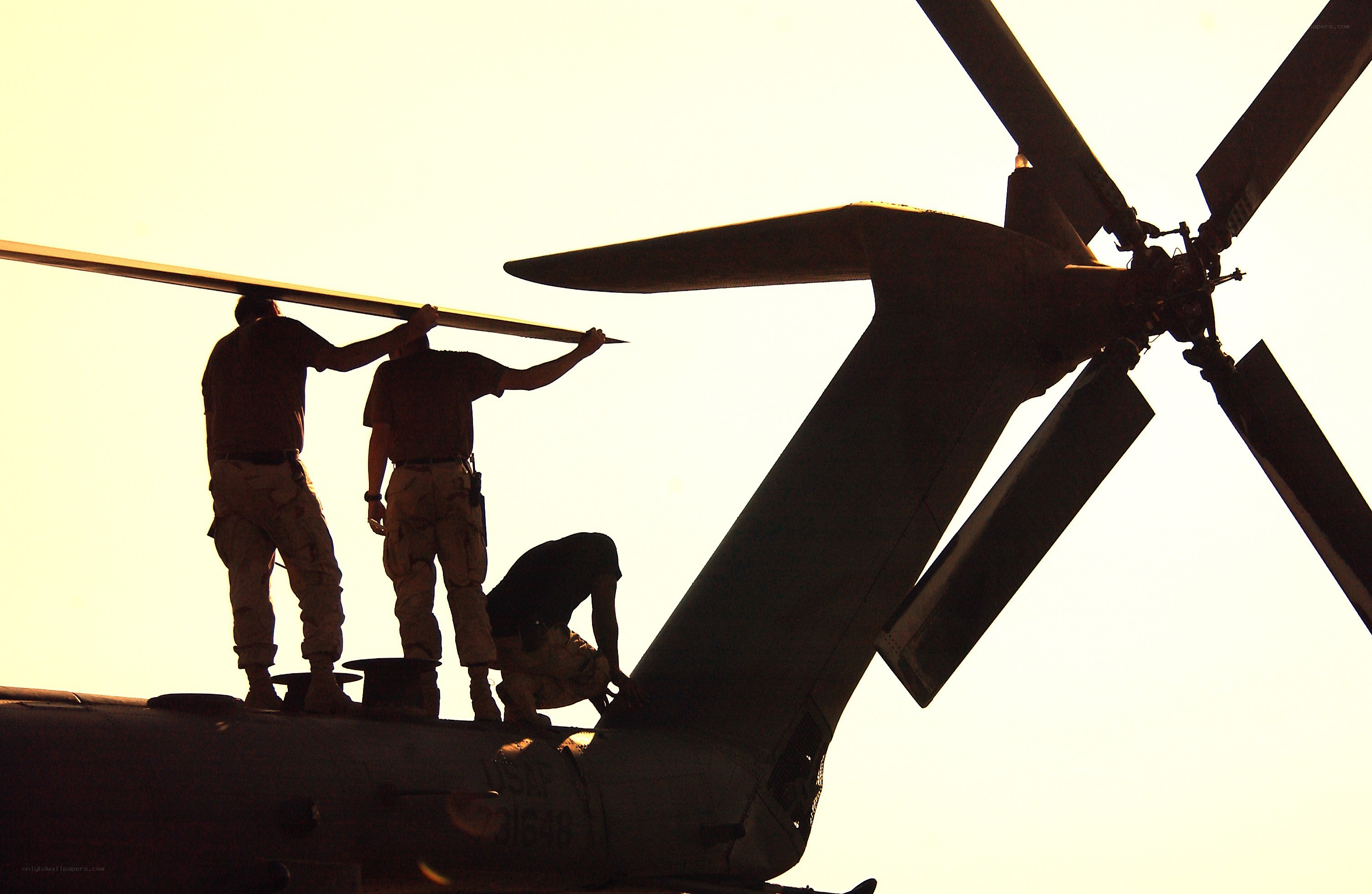 Soldiers working on helicopter
