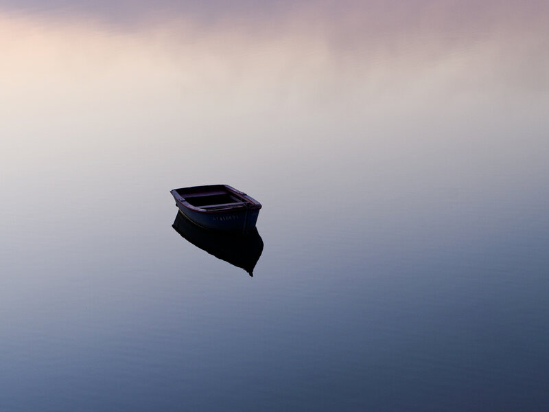 solitary boat on calm water