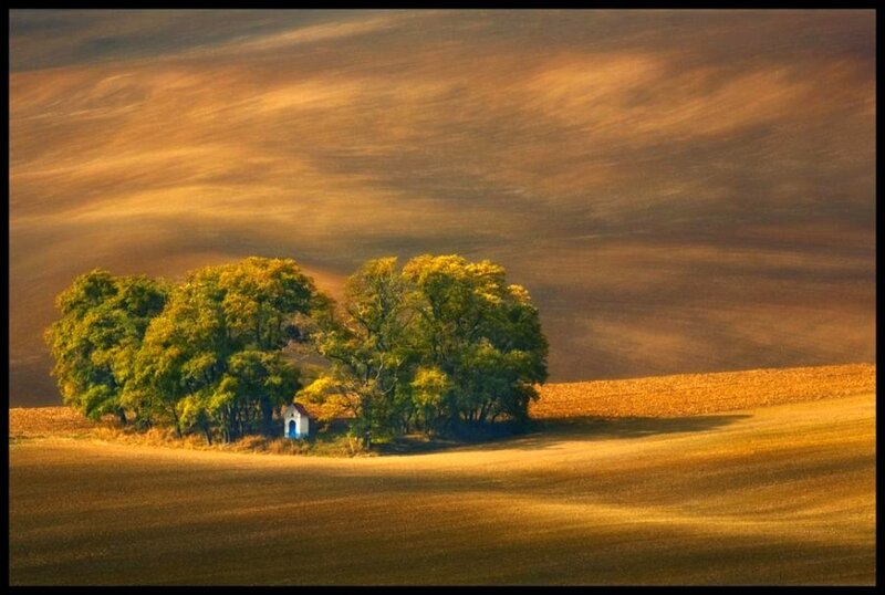 Solitary chapel in autumn field