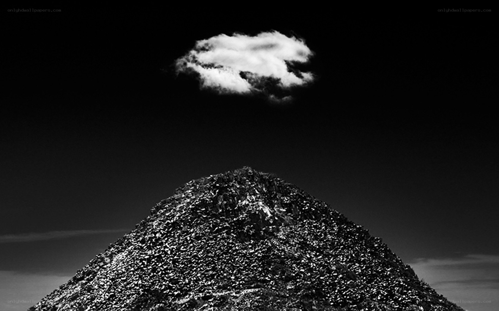 solitary cloud over mountain peak