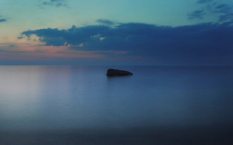 Solitary rock at dusk