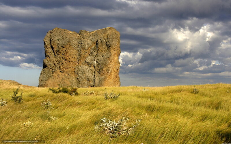 Solitary rock formation in grassland