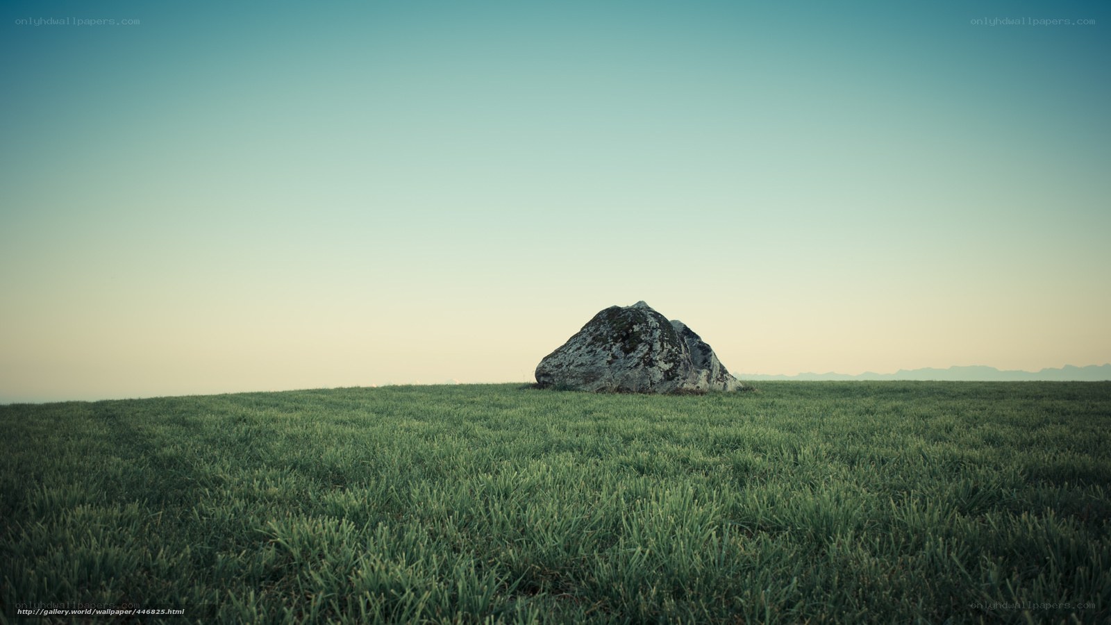 Solitary rock in a green field