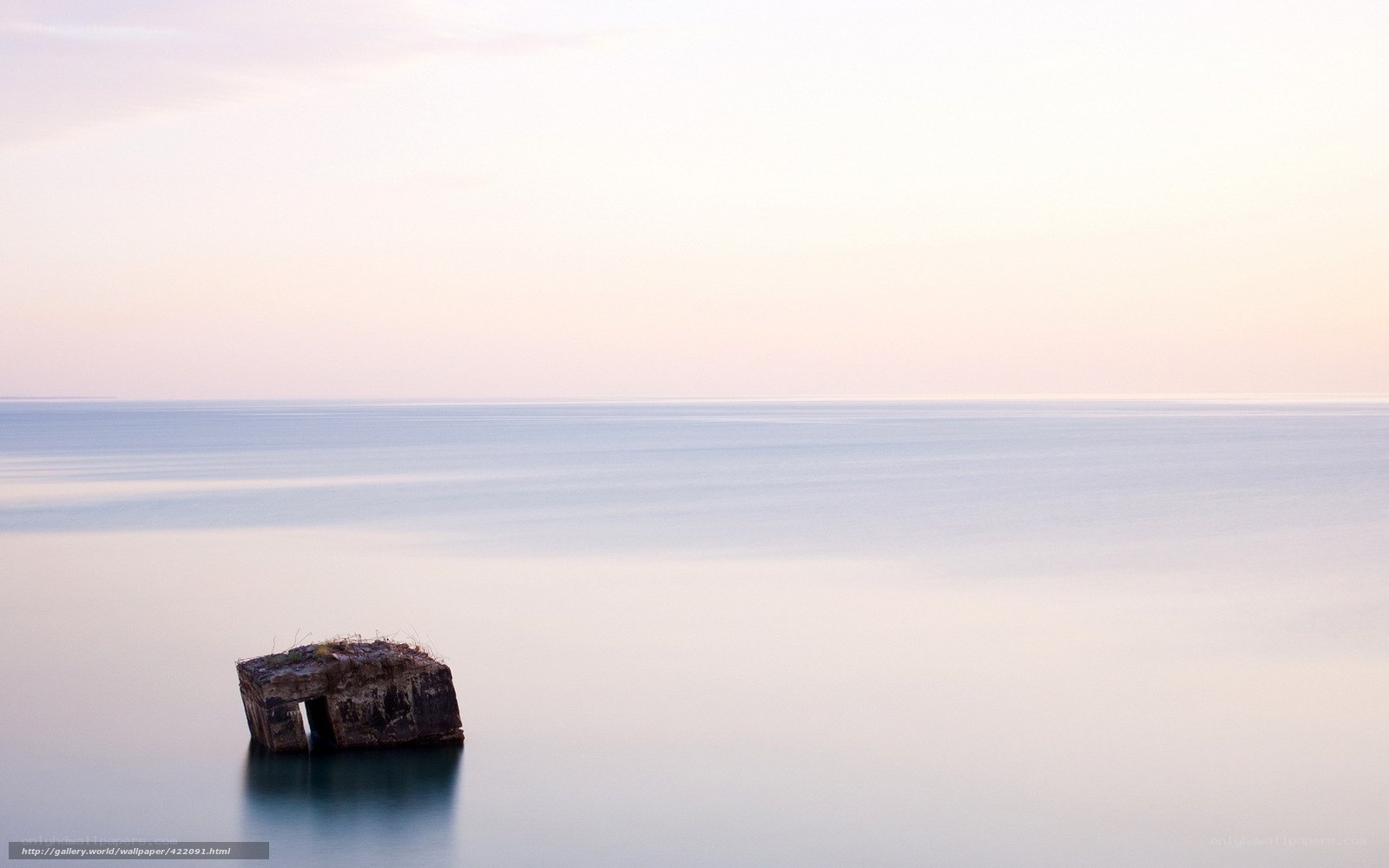 Solitary rock in calm sea