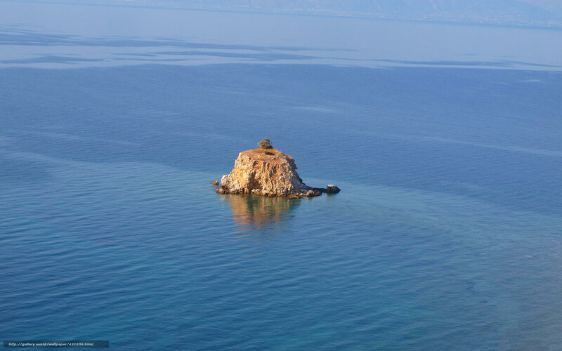 Solitary rock island in blue sea
