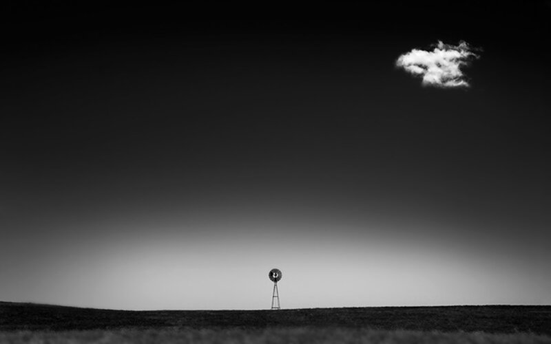 Solitary windmill under a lone cloud