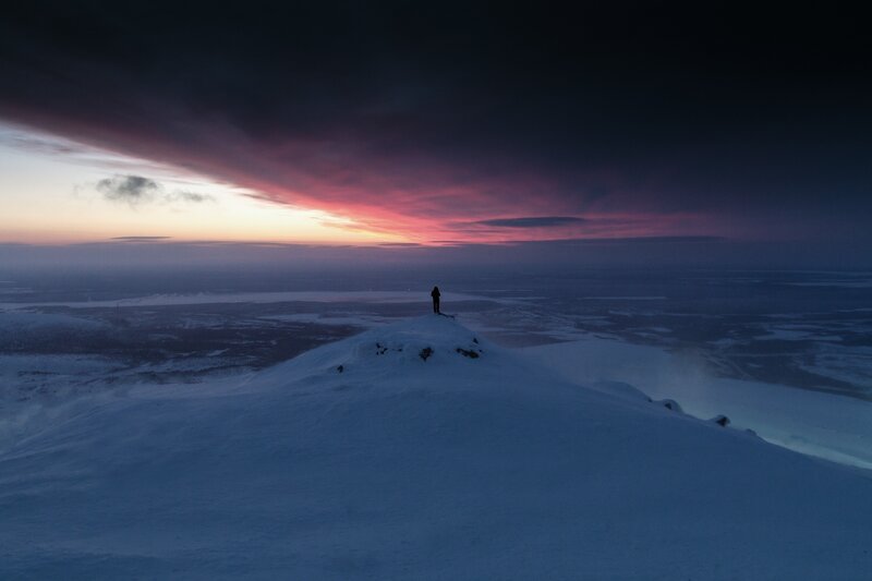 Solo figure on snowy peak