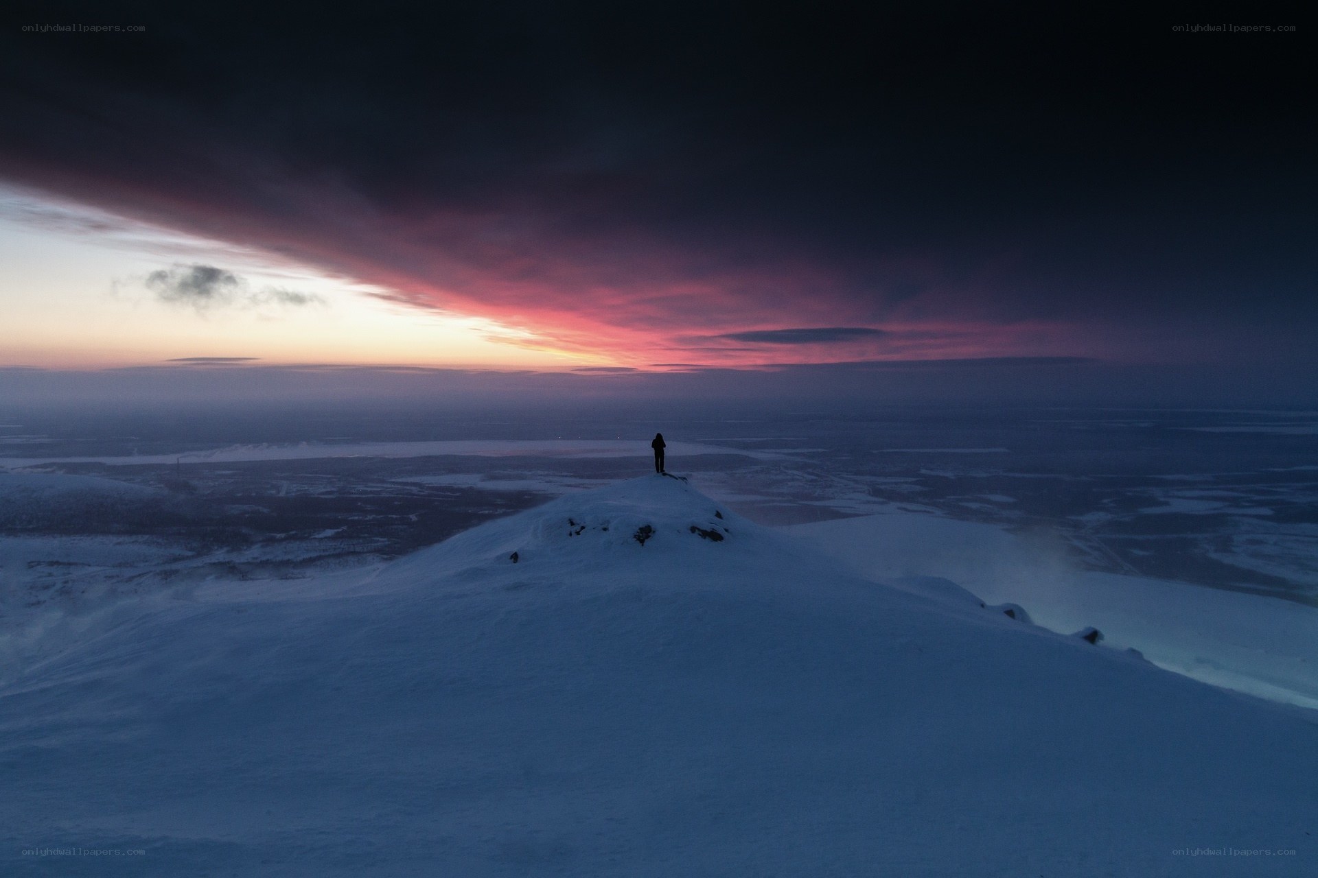 Solo figure on snowy peak
