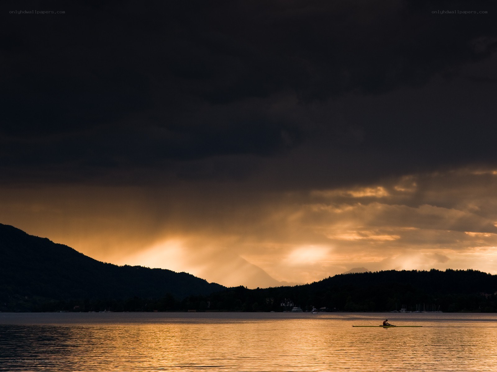 Solo rower at sunset