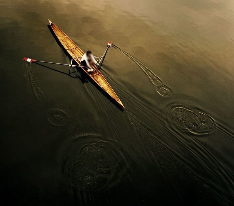 Solo rower on calm water