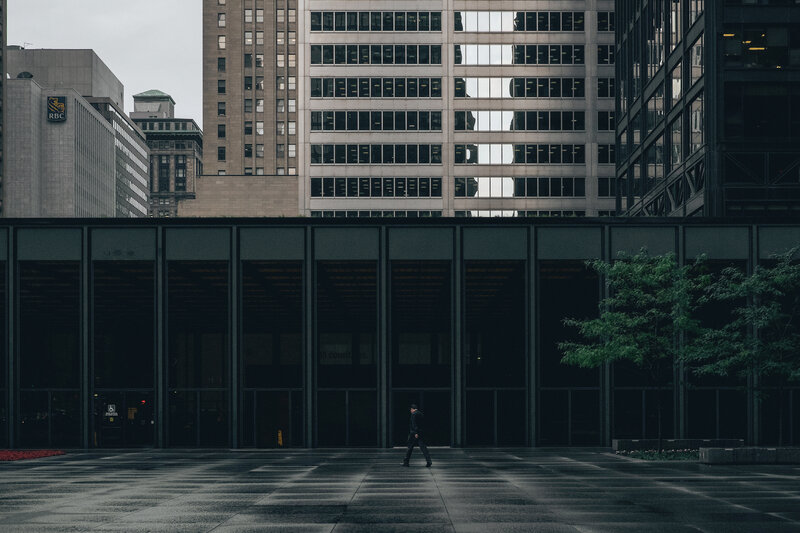 Solo walker in urban plaza