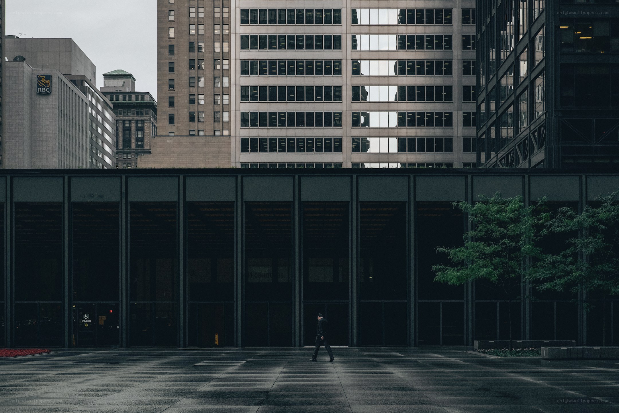 Solo walker in urban plaza