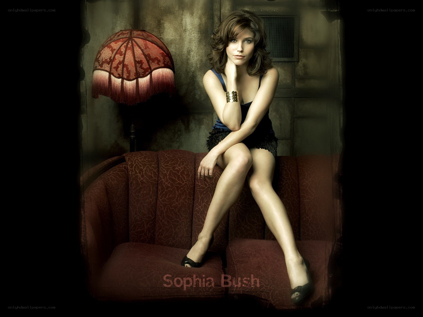 Sophia Bush on a red couch
