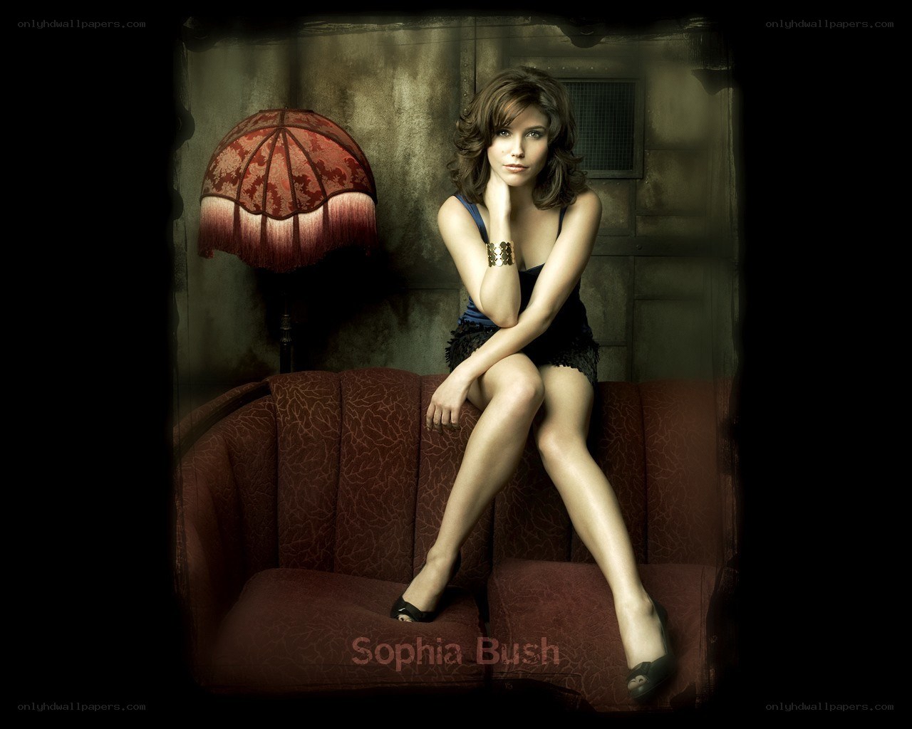 Sophia Bush on a red couch