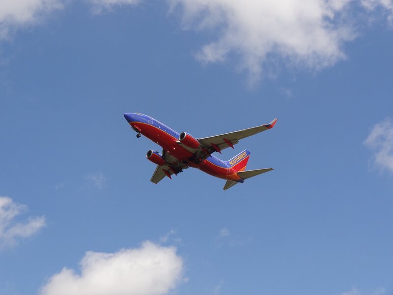 Southwest Airlines Plane — Blue, Clear, Afternoon, Photograph, Airplane, Sky, Clouds