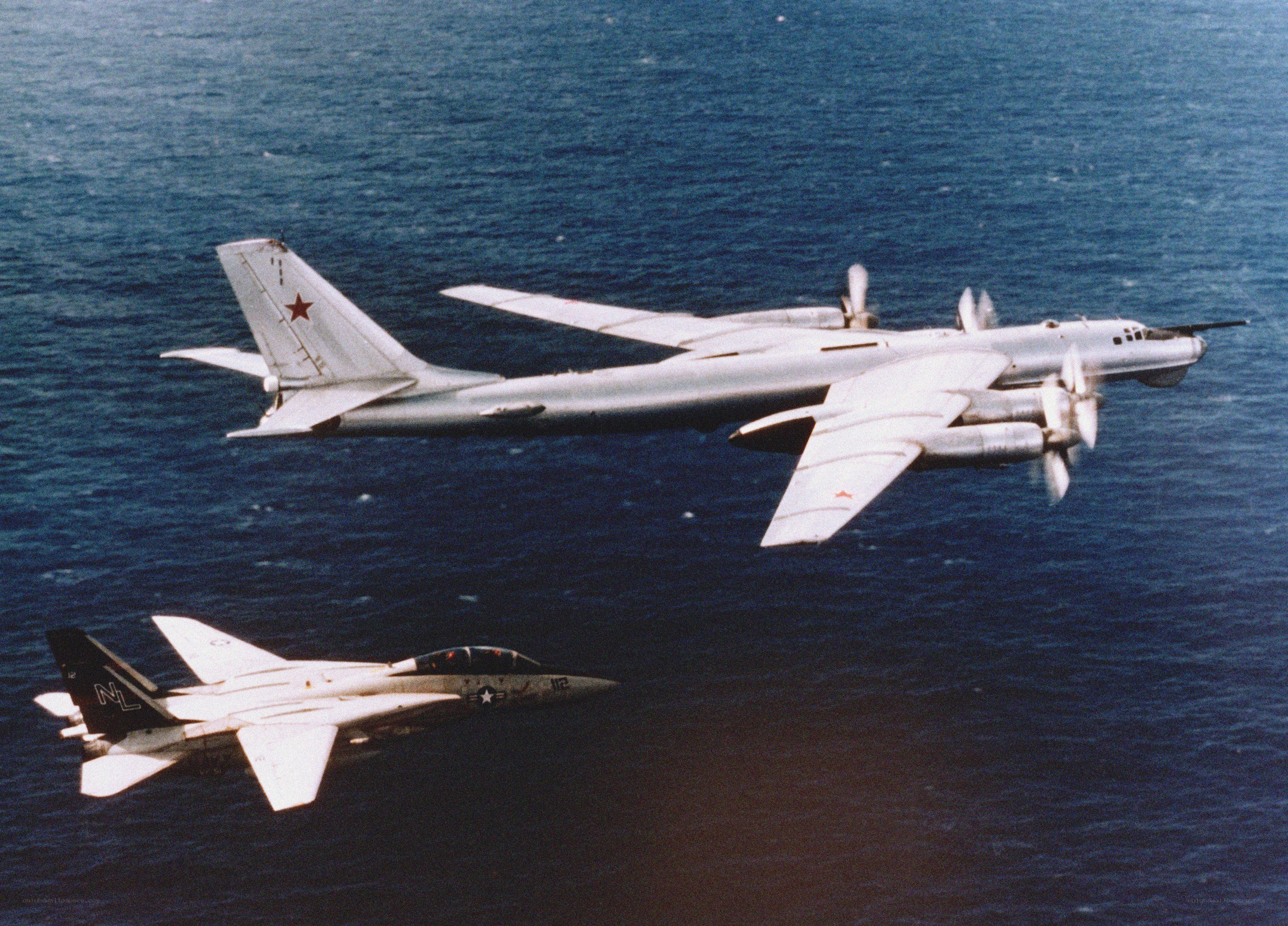 Soviet bomber and US fighter over ocean