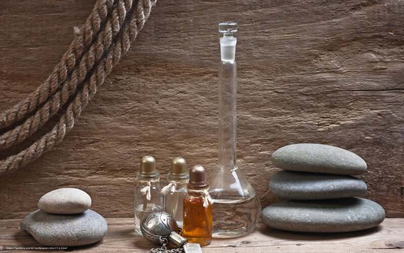 Spa bottles and stones on wood