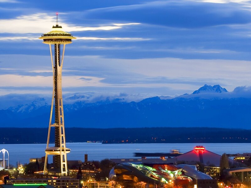 Space Needle at dusk with mountains