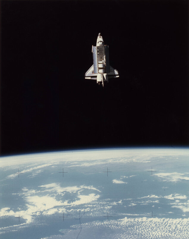 Space shuttle above Earth