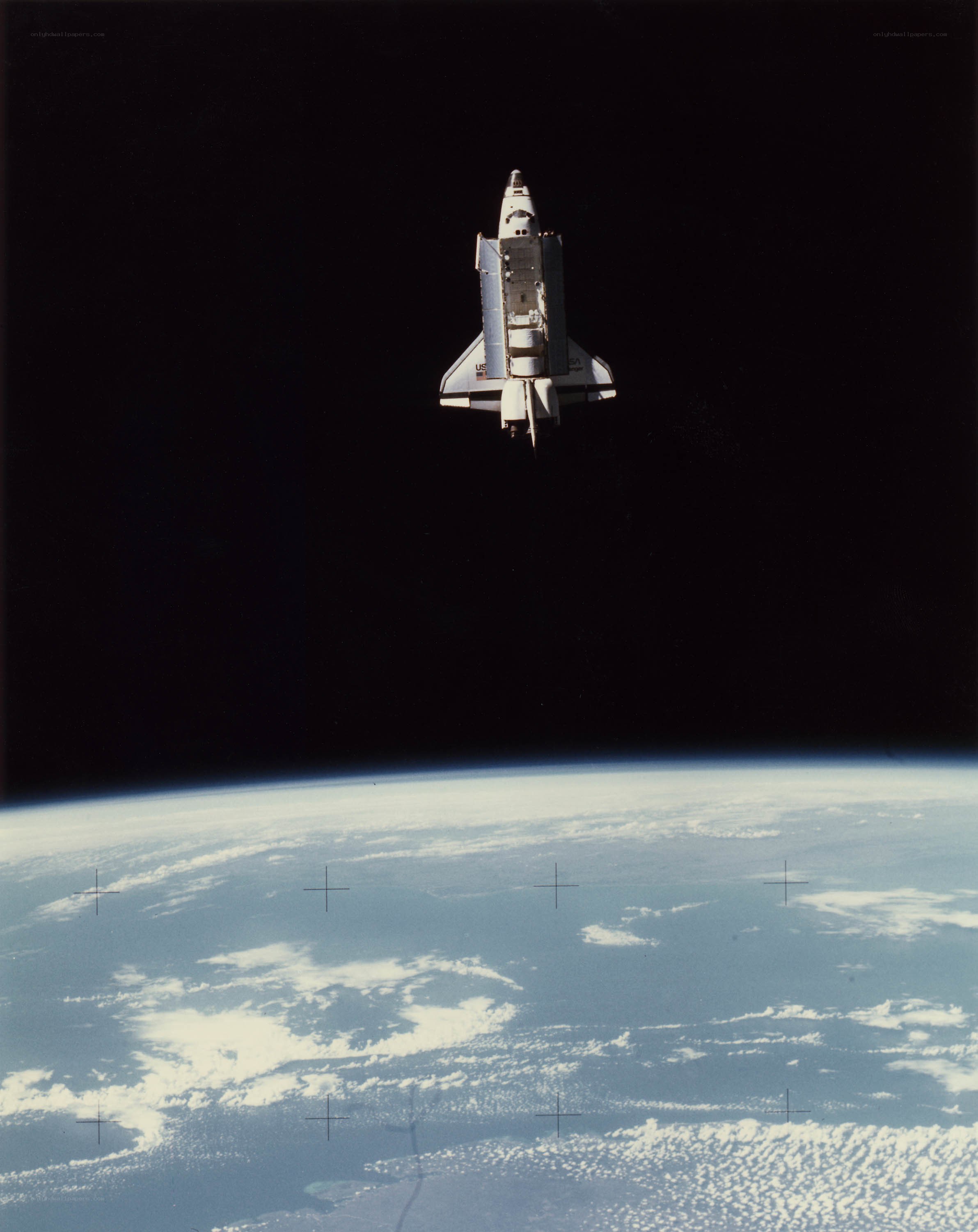 Space shuttle above Earth