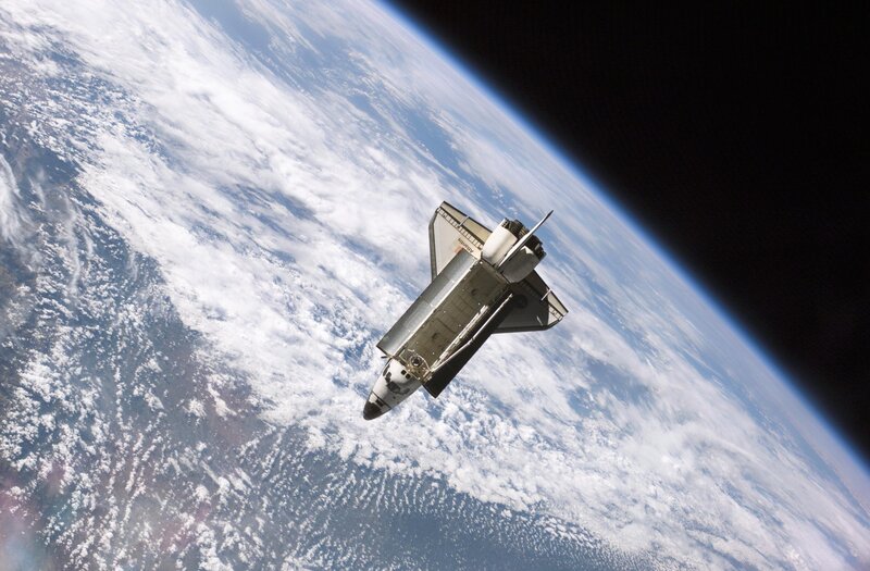 Space shuttle above Earth