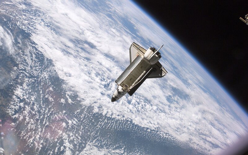 Space shuttle above Earth