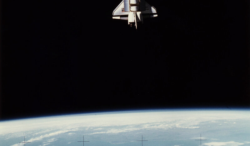 Space shuttle above Earth