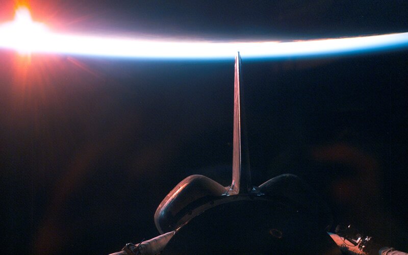 Space shuttle above Earth