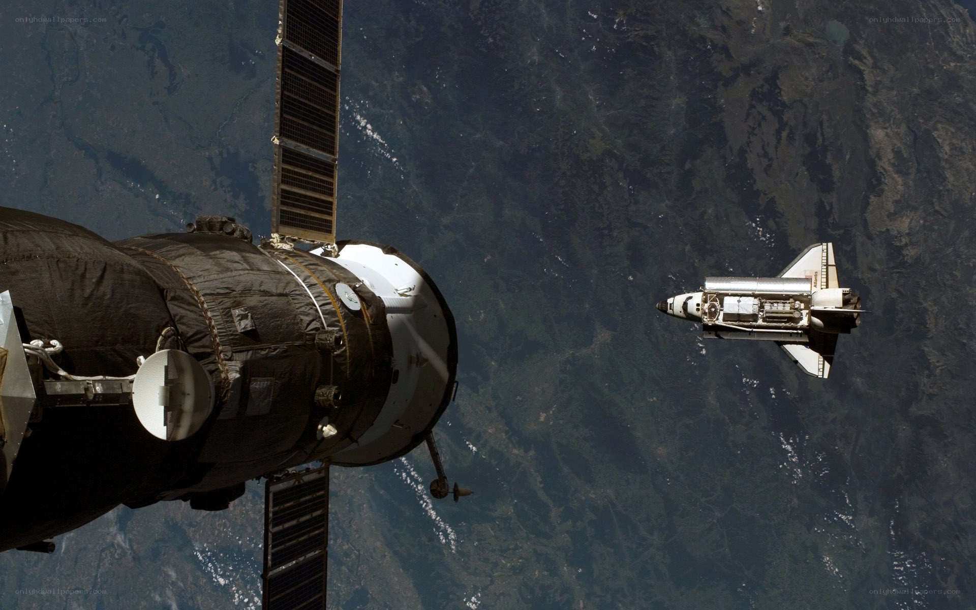 Space shuttle and satellite in orbit