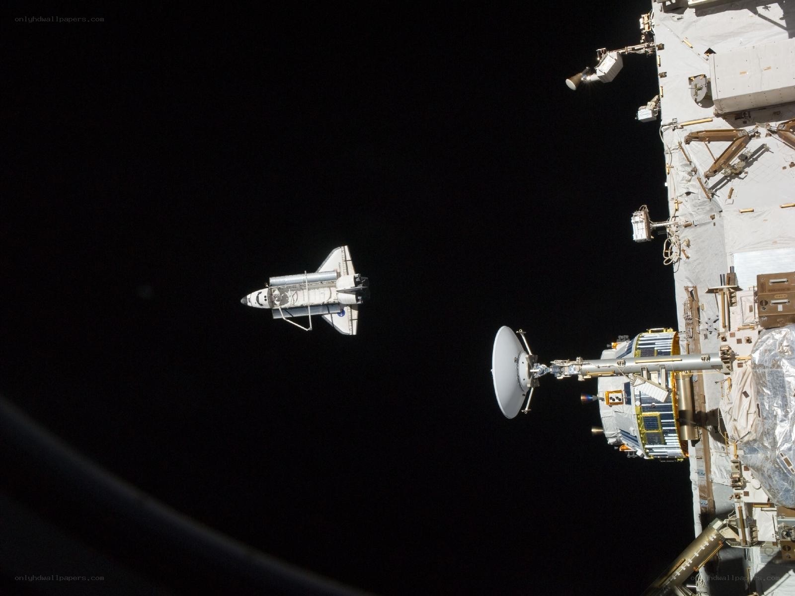 Space shuttle approaching space station