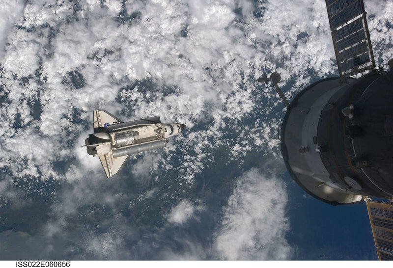 Space shuttle approaching space station