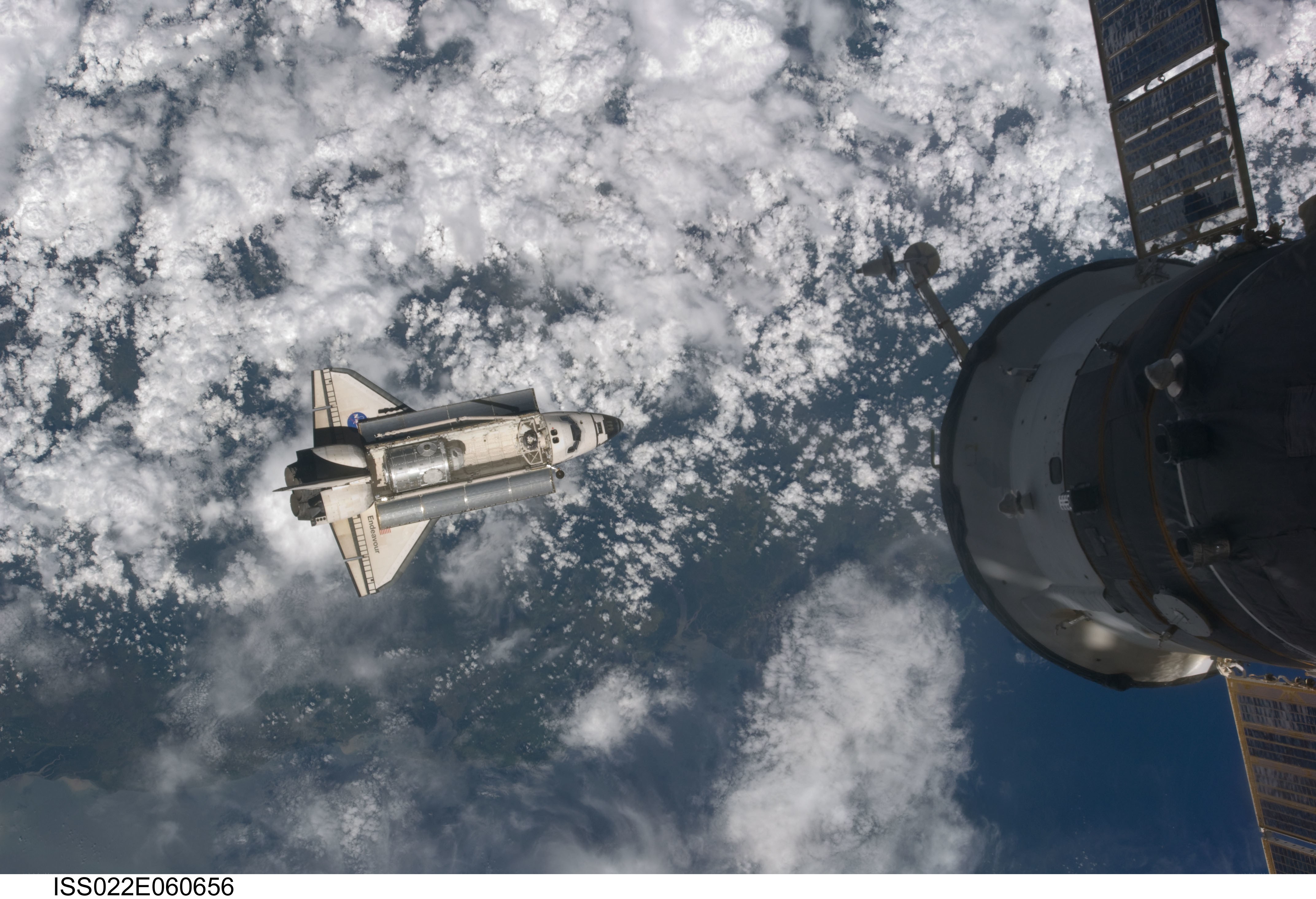 Space shuttle approaching space station