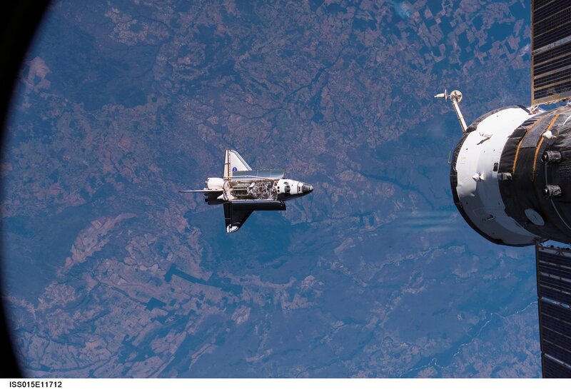 Space shuttle approaching space station
