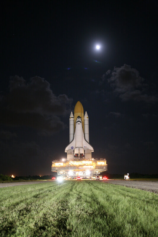 Space shuttle at night under moonlight