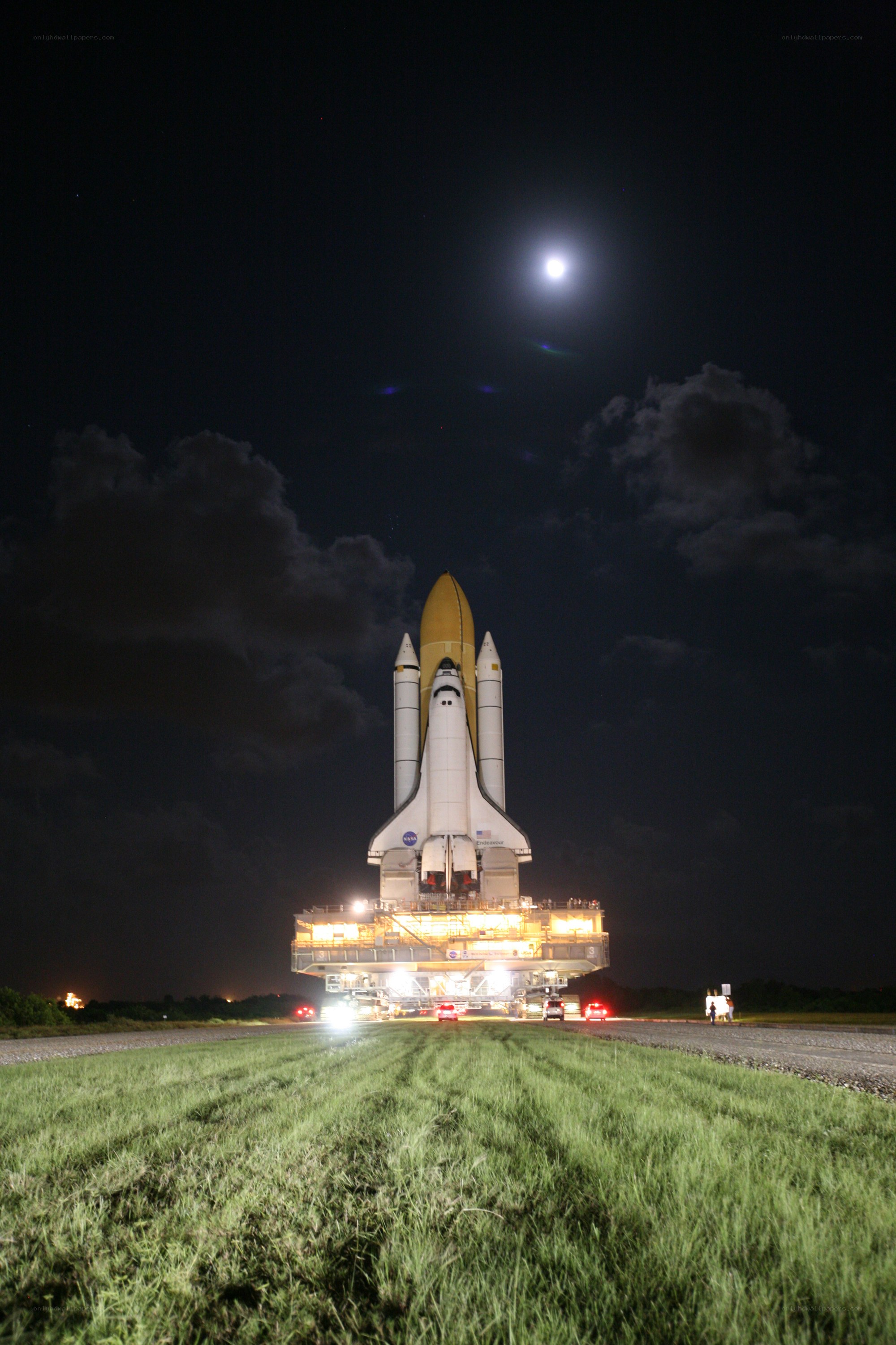 Space shuttle at night under moonlight