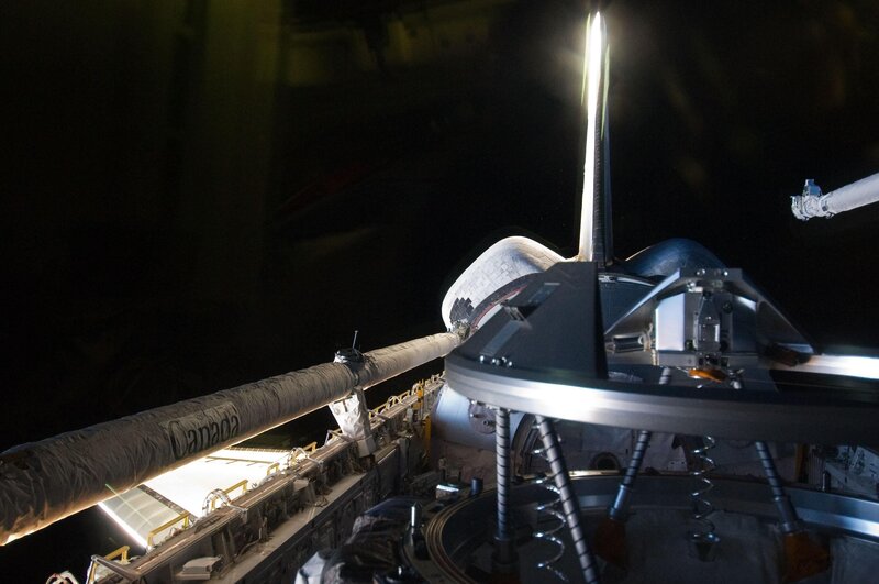 Space shuttle docking at night