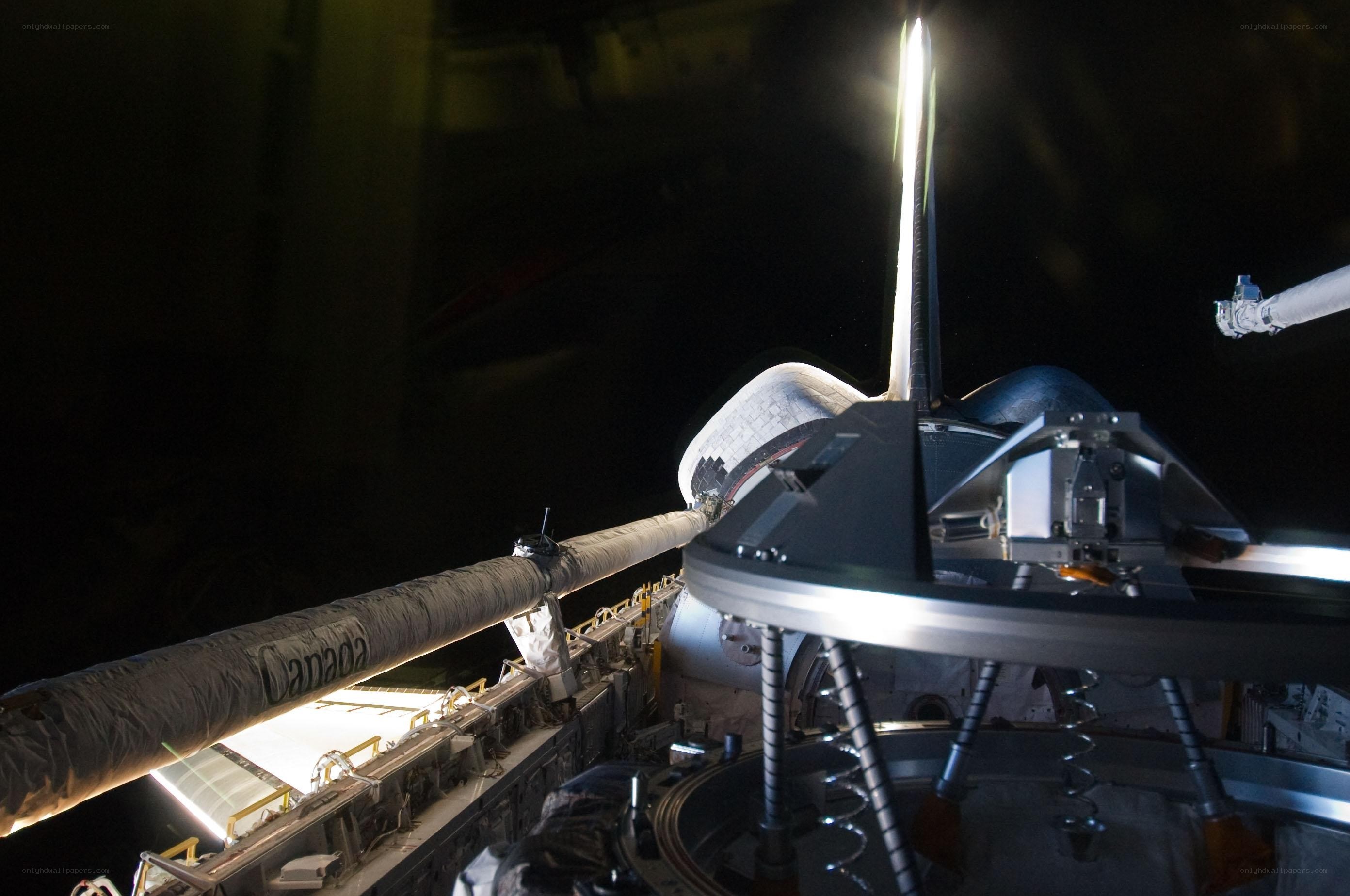 Space shuttle docking at night