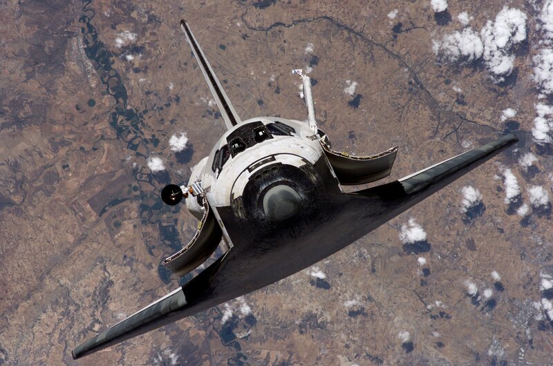 Space Shuttle in Orbit — White, Dramatic, Photograph, Earth, Clouds