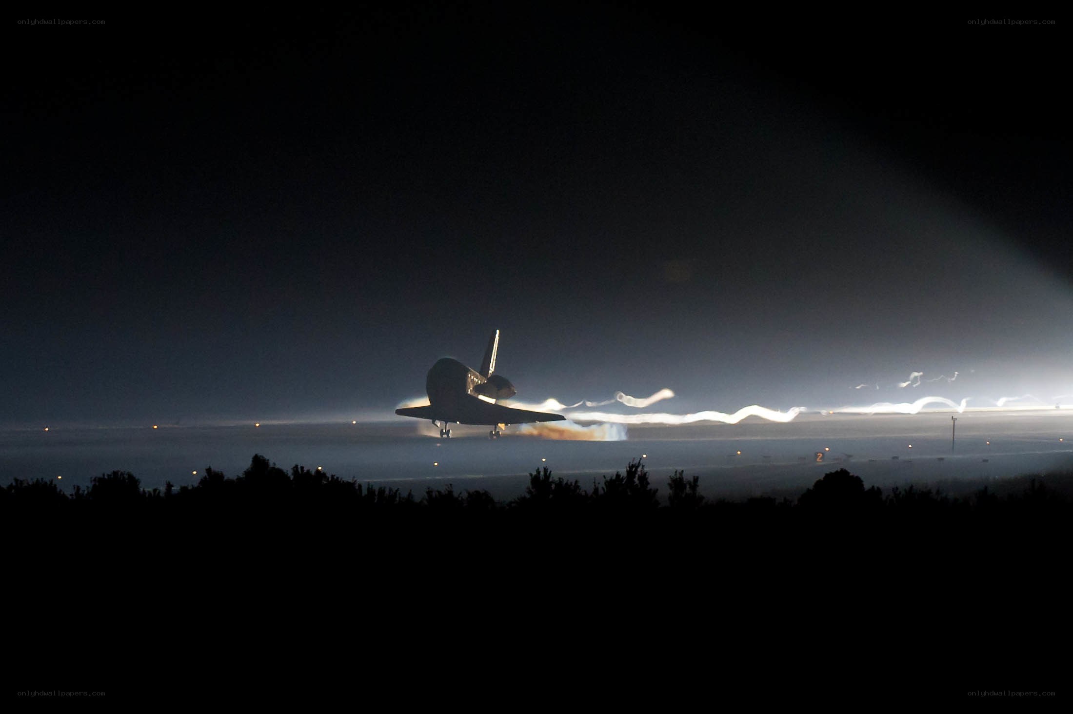 Space shuttle landing at night