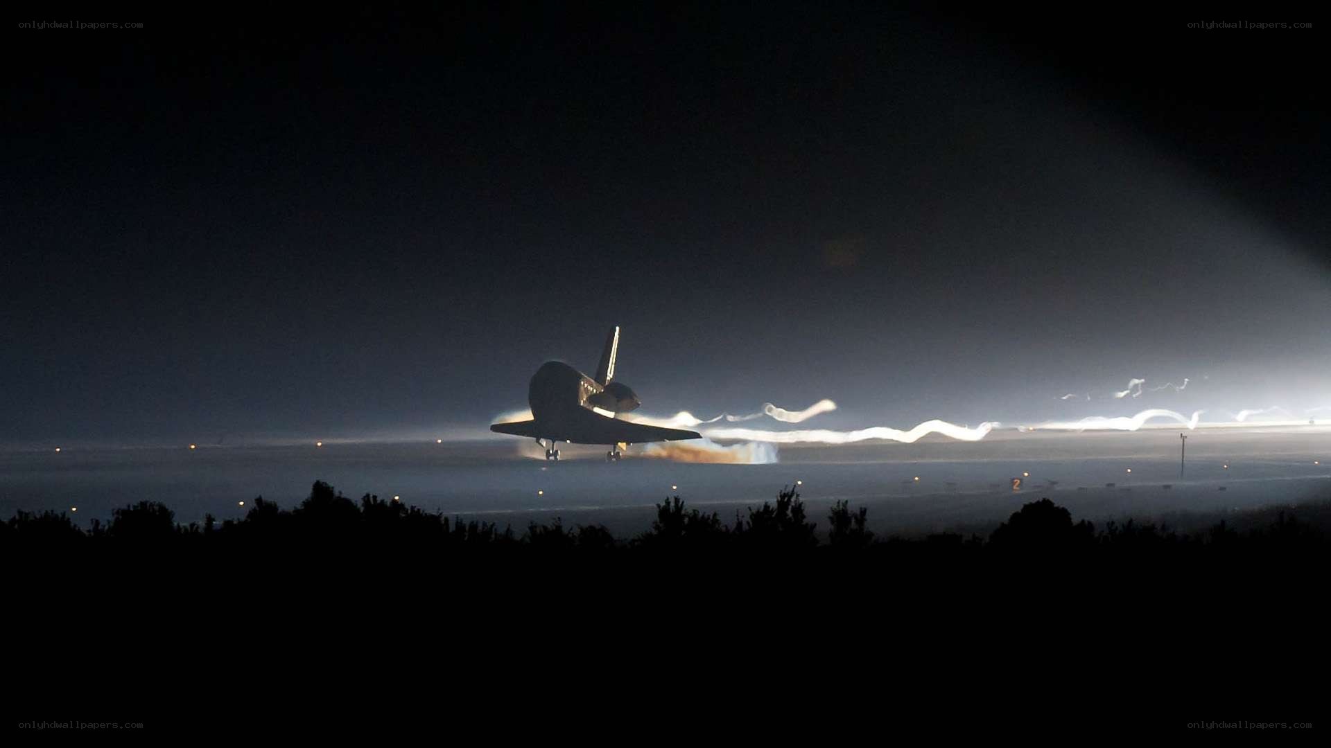 Space shuttle landing at night